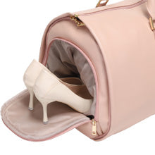 Pink handbag with a white high-heeled shoe inside, on a light gray background