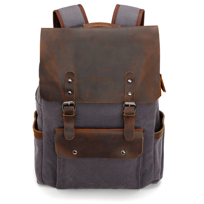 Gray and brown backpack with leather accents on a white background