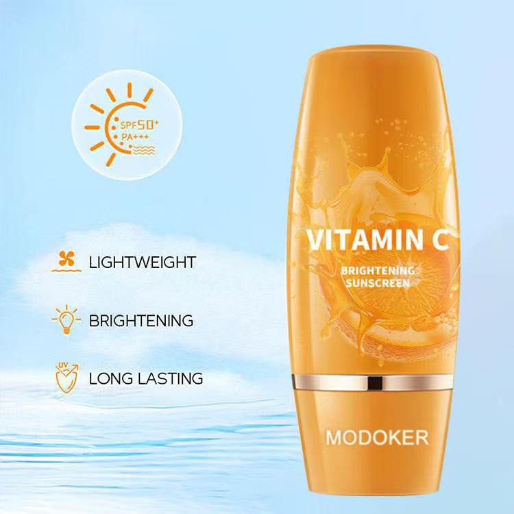 Orange skincare bottle labeled 'Vitamin C Brightening Sunscreen' by Modoker on a light blue background.